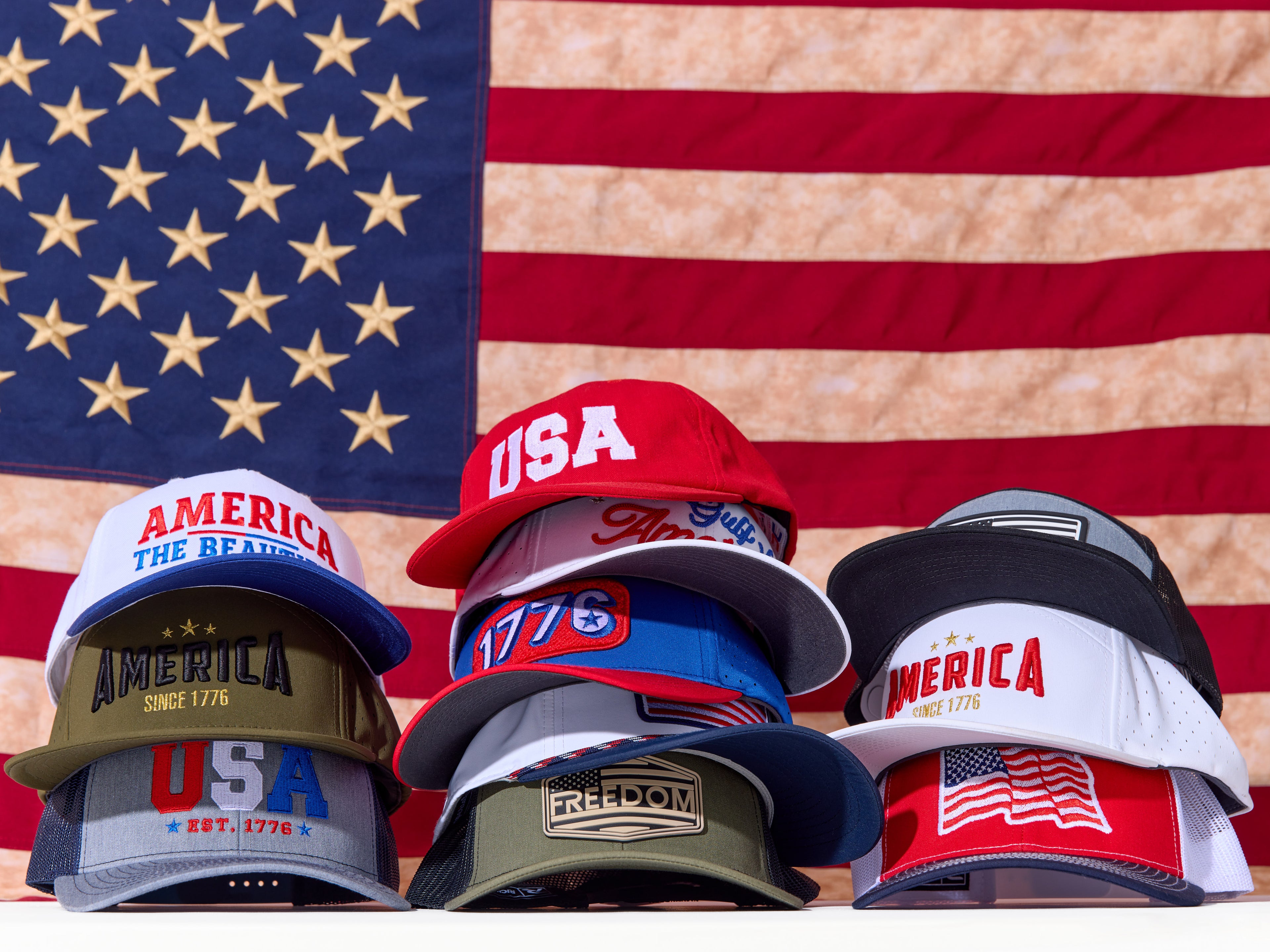 Collection of hats with American-themed designs on an American flag background